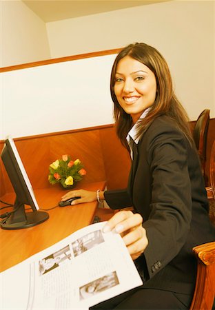 formal mouse computer - Portrait of a businesswoman working on a computer and holding a sheet of paper Stock Photo - Premium Royalty-Free, Code: 630-01131580