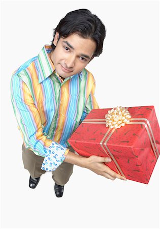 striped wrapping paper - High angle view of a young man holding a gift Stock Photo - Premium Royalty-Free, Code: 630-01191663
