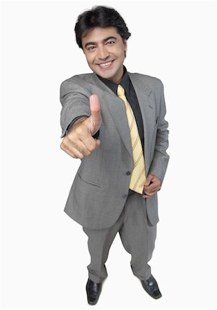 shoe overhead on white - High angle view of a businessman showing a thumbs up sign Stock Photo - Premium Royalty-Free, Code: 630-01191690