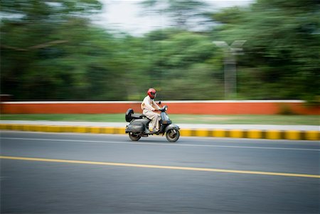 pictures of people riding scooters - Side profile of a man riding a scooter, New Delhi, India Stock Photo - Premium Royalty-Free, Code: 630-01191778