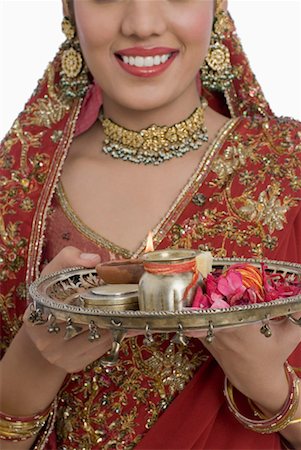 Close-up of a young woman holding a plate of religious offerings Stock Photo - Premium Royalty-Free, Code: 630-01191962
