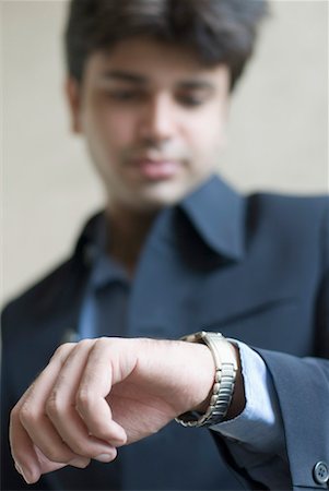 Close-up of a businessman looking at his wristwatch Stock Photo - Premium Royalty-Free, Code: 630-01192077