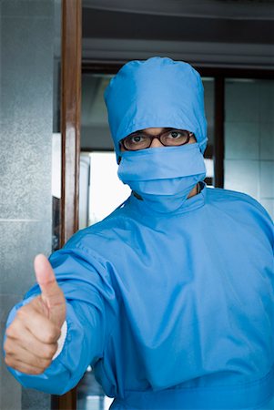 Close-up of a surgeon making a thumbs up sign Stock Photo - Premium Royalty-Free, Code: 630-01192089