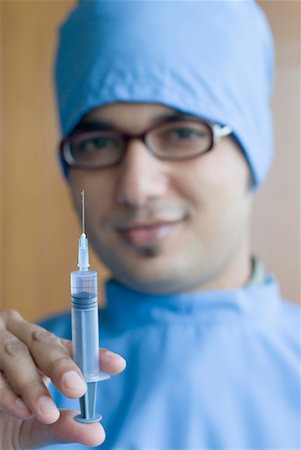 doctor syringe close up - Portrait of a surgeon holding a syringe Stock Photo - Premium Royalty-Free, Code: 630-01192091