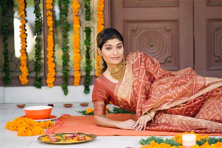 flower decoration in indian wedding - Portrait of a young woman lying on a mat Stock Photo - Premium Royalty-Free, Code: 630-01192224