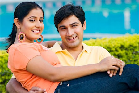 Portrait of a young man carrying a young woman and smiling Stock Photo - Premium Royalty-Free, Code: 630-01192351