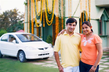 diwali couple images - Portrait of a young couple standing in front of a decorated house Stock Photo - Premium Royalty-Free, Code: 630-01192378