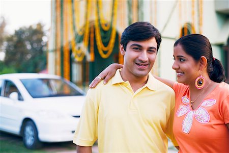 flower decoration in indian wedding - Close-up of a young couple standing in front of a decorated house and smiling Stock Photo - Premium Royalty-Free, Code: 630-01192379