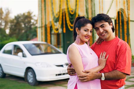 flower decoration in indian wedding - Portrait of a young couple standing in front of a decorated house and smiling Stock Photo - Premium Royalty-Free, Code: 630-01192380