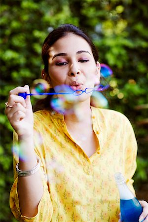 Close-up of a young woman blowing bubbles Stock Photo - Premium Royalty-Free, Code: 630-01192666