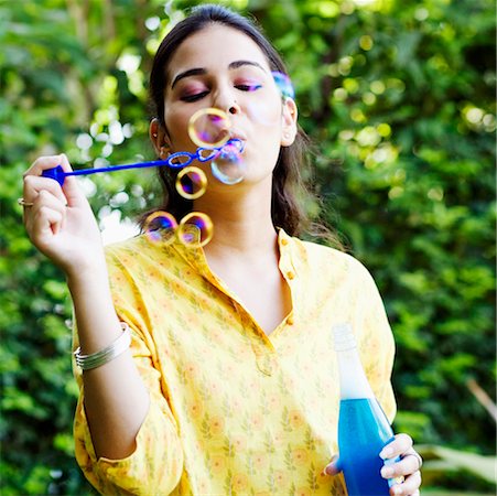 Close-up of a young woman blowing bubbles Stock Photo - Premium Royalty-Free, Code: 630-01192667