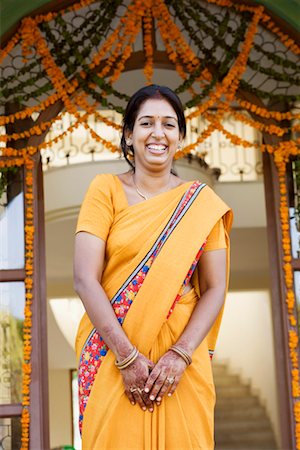 flower decoration in indian wedding - Portrait of a young woman smiling Stock Photo - Premium Royalty-Free, Code: 630-01192672