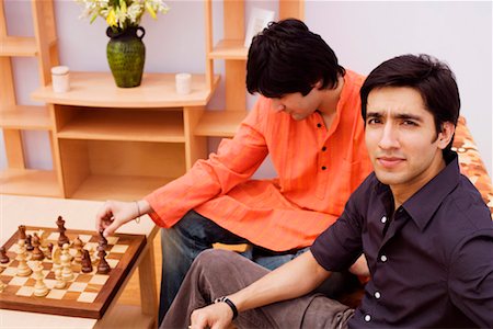 Premium Photo  Two young man are playing chess