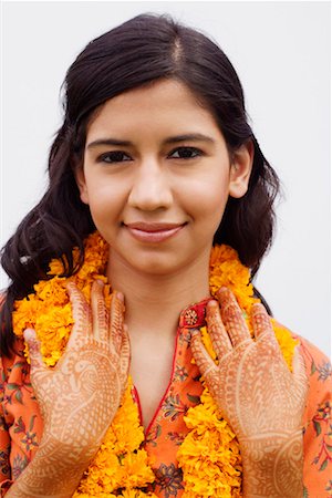 Portrait of a young woman wearing garlands Stock Photo - Premium Royalty-Free, Code: 630-01192888