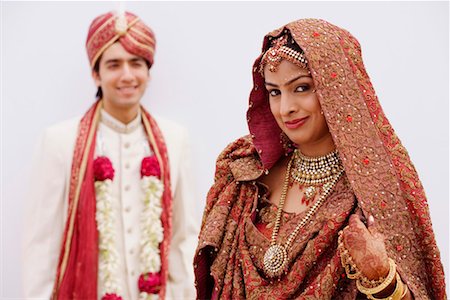 Portrait of a bride smiling with her groom standing behind her Stock Photo - Premium Royalty-Free, Code: 630-01192937