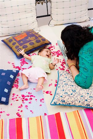 High angle view of a baby girl lying on the bed Stock Photo - Premium Royalty-Free, Code: 630-01192949