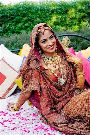 High angle view of a bride in a traditional wedding dress lying on the bed Stock Photo - Premium Royalty-Free, Code: 630-01193006