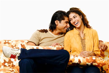 simsearch:640-01356582,k - Close-up of a young couple sitting on a couch and smiling Stock Photo - Premium Royalty-Free, Code: 630-01296726