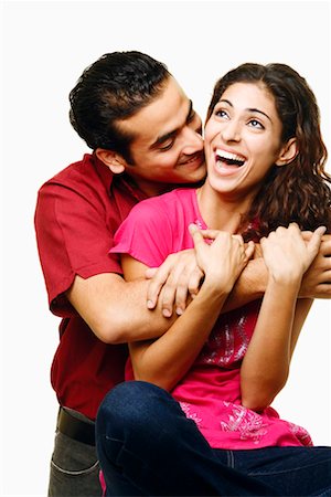 simsearch:640-01356582,k - Young man embracing a young woman from her behind and smiling Stock Photo - Premium Royalty-Free, Code: 630-01296739