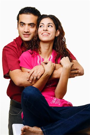 simsearch:640-01356582,k - Young man embracing a young woman from behind and smiling Stock Photo - Premium Royalty-Free, Code: 630-01296810