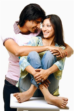 simsearch:640-01356582,k - Young man embracing a young woman from her behind and smiling Stock Photo - Premium Royalty-Free, Code: 630-01296827