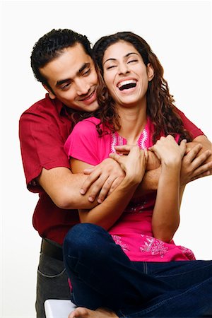 simsearch:640-01356582,k - Young man embracing a young woman from her behind and smiling Stock Photo - Premium Royalty-Free, Code: 630-01296851