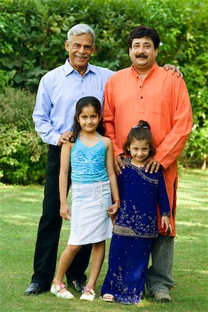 father and son in kurta - Portrait of a senior man with his son and two granddaughters standing in a garden and smiling Stock Photo - Premium Royalty-Free, Code: 630-01296853