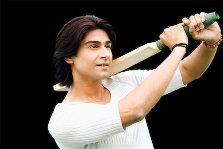 Close-up of a young man swinging a cricket bat Stock Photo - Premium Royalty-Free, Code: 630-01296878