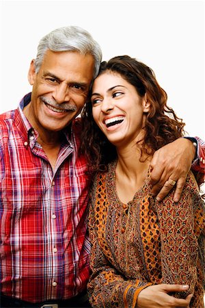 Close-up of a senior man smiling with his arm around his daughter Stock Photo - Premium Royalty-Free, Code: 630-01296962