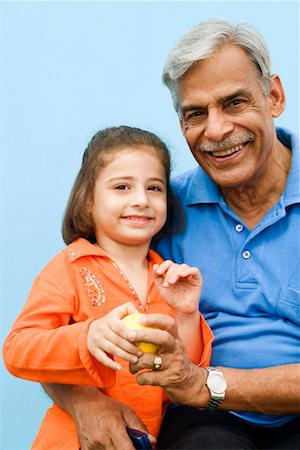 Portrait of a senior man with his granddaughter smiling Stock Photo - Premium Royalty-Free, Code: 630-01296973