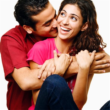 simsearch:640-01356582,k - Close-up of a young man embracing a young woman from her behind and smiling Stock Photo - Premium Royalty-Free, Code: 630-01297052