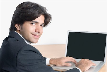 Portrait of a businessman using a laptop Stock Photo - Premium Royalty-Free, Code: 630-01490516