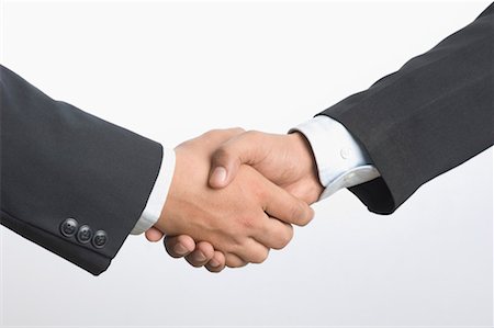 Close-up of two businessmen shaking hands Stock Photo - Premium Royalty-Free, Code: 630-01490522