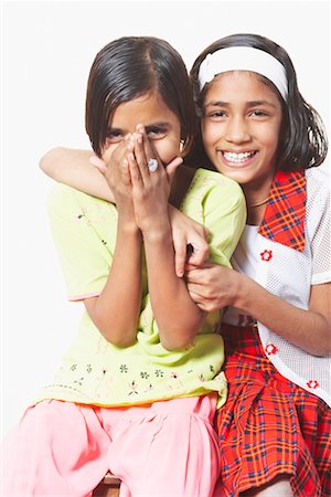 Portrait of a girl sitting with her arm around another girl Stock Photo - Premium Royalty-Free, Code: 630-01490615