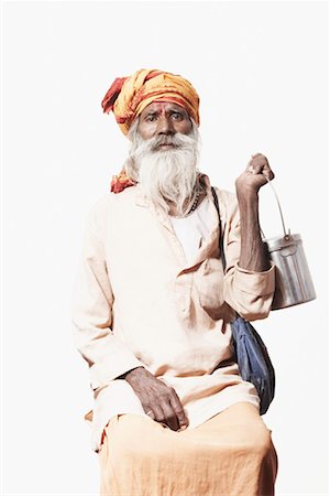 Portrait of a sadhu sitting and holding a utensil Stock Photo - Premium Royalty-Free, Code: 630-01490610