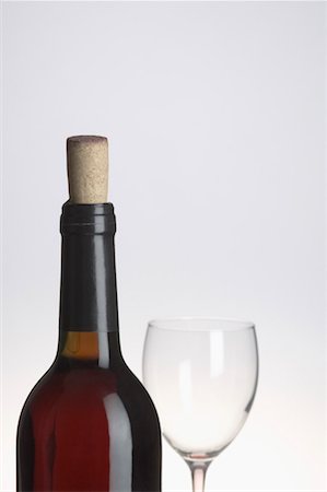Close-up of a wine bottle and a wine glass Stock Photo - Premium Royalty-Free, Code: 630-01490783