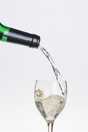 Wine pouring from a bottle into a glass Stock Photo - Premium Royalty-Free, Code: 630-01490791