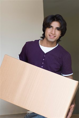 fat indian man - Close-up of a young man holding a cardboard box Stock Photo - Premium Royalty-Free, Code: 630-01490815