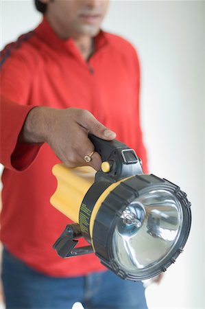 Mid section view of a person holding a flashlight Stock Photo - Premium Royalty-Free, Code: 630-01491089