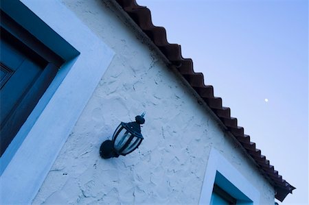 Low angle view of a lamp on the wall of a house Stock Photo - Premium Royalty-Free, Code: 630-01491140