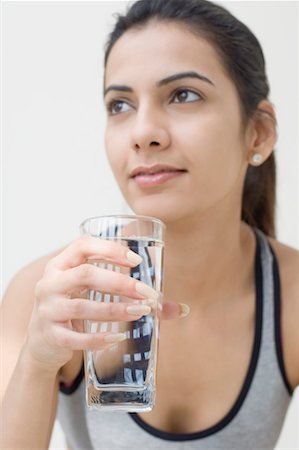 Close-up of a young woman holding a glass of water Stock Photo - Premium Royalty-Free, Code: 630-01491196