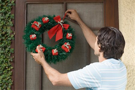 simsearch:630-01491245,k - Rear view of a young man hanging wreath on a door Stock Photo - Premium Royalty-Free, Code: 630-01491223