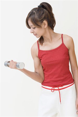 simsearch:630-01490614,k - Young woman exercising with a dumbbell Fotografie stock - Premium Royalty-Free, Codice: 630-01491296