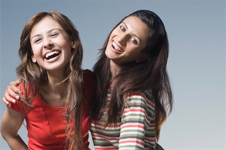 simsearch:630-01874412,k - Portrait of a young woman laughing with her arms around another woman Foto de stock - Sin royalties Premium, Código: 630-01491379