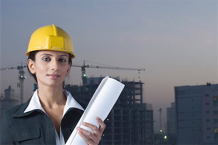 reel to reel camera - Portrait of a businesswoman wearing a hardhat and holding a blueprint Stock Photo - Premium Royalty-Free, Code: 630-01491407
