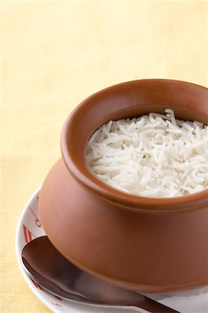 Close-up of a bowl of boiled rice with a spoon on a plate Stock Photo - Premium Royalty-Free, Code: 630-01491448