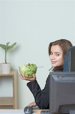 Portrait of a businesswoman holding a bowl of salad Stock Photo - Premium Royalty-Free, Code: 630-01491498