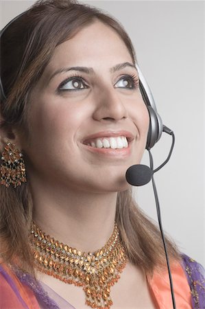 simsearch:630-01491629,k - Close-up of a young woman wearing a headset Stock Photo - Premium Royalty-Free, Code: 630-01491629