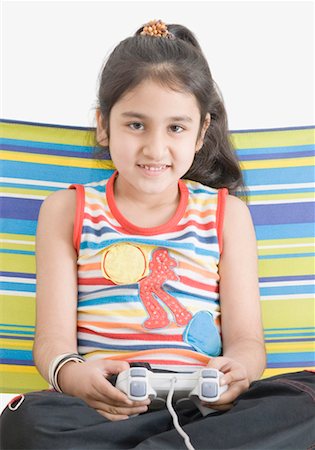 simsearch:630-01492101,k - Portrait of a girl playing video game Stock Photo - Premium Royalty-Free, Code: 630-01492108