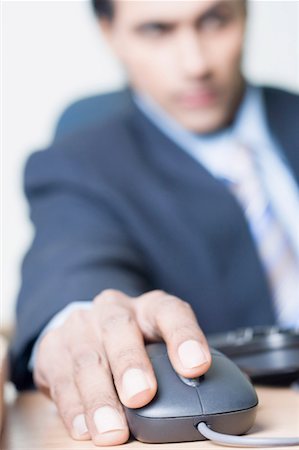 Close-up of a businessman using a computer mouse Stock Photo - Premium Royalty-Free, Code: 630-01492169